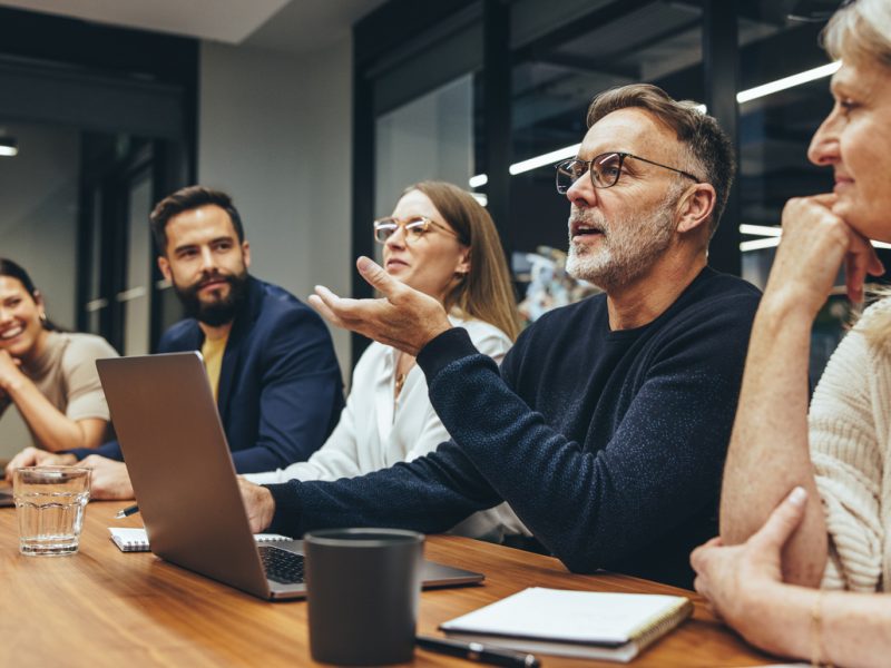 Executive using strong communication and leadership skills in a collaborative team setting