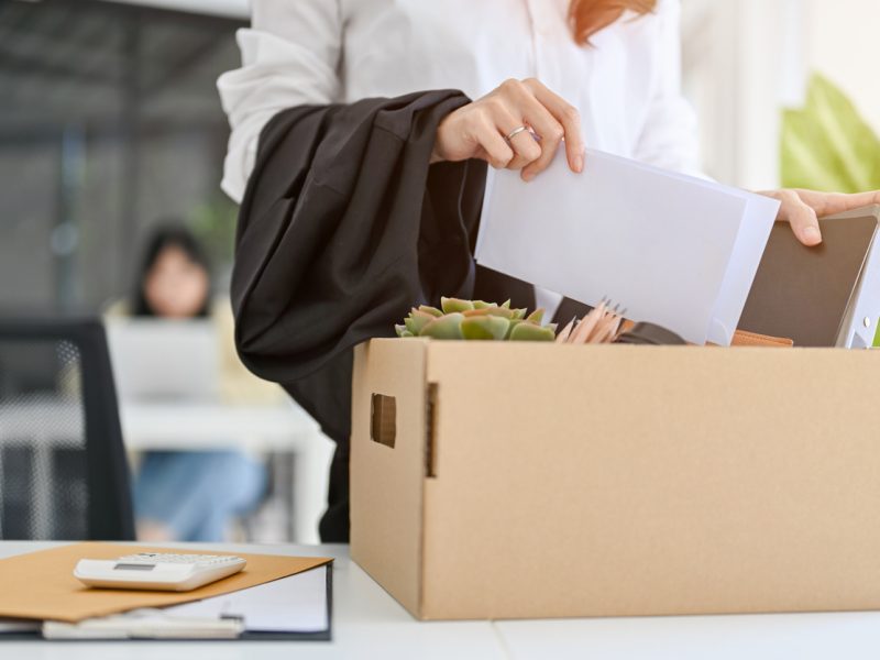 Executive packing up office belongings after being laid off or fired