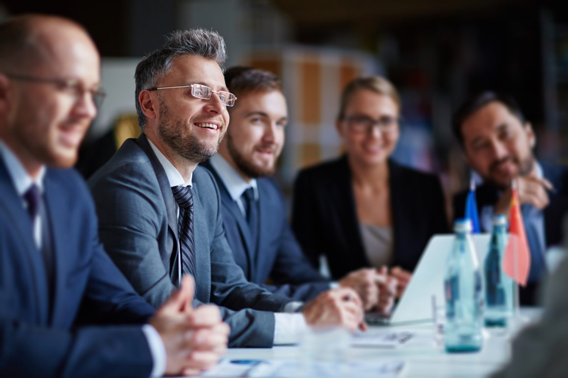 Senior business leaders in a meeting, demonstrating engagement and leadership skills