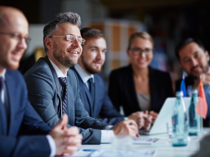 Senior business leaders in a meeting, demonstrating engagement and leadership skills